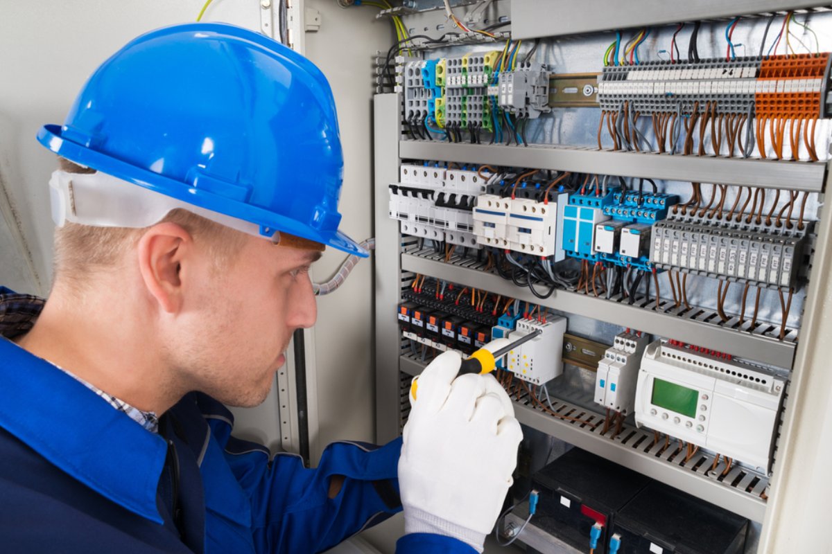 Elektriker führt E-Check in Berlin mit kalibriertem Messgerät an einer Steckdose durch